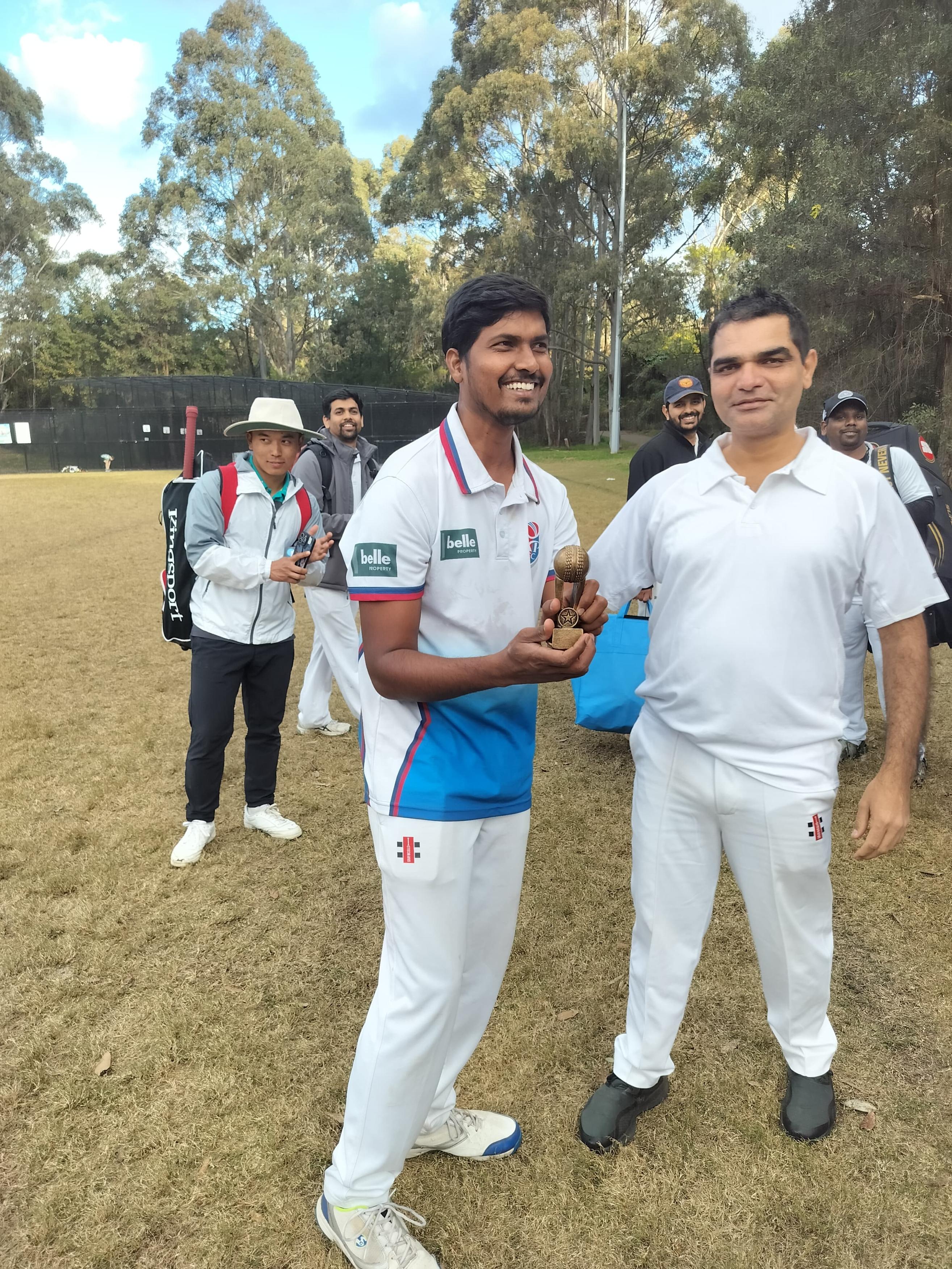 Two Tigers players congratulating each other with a trophy